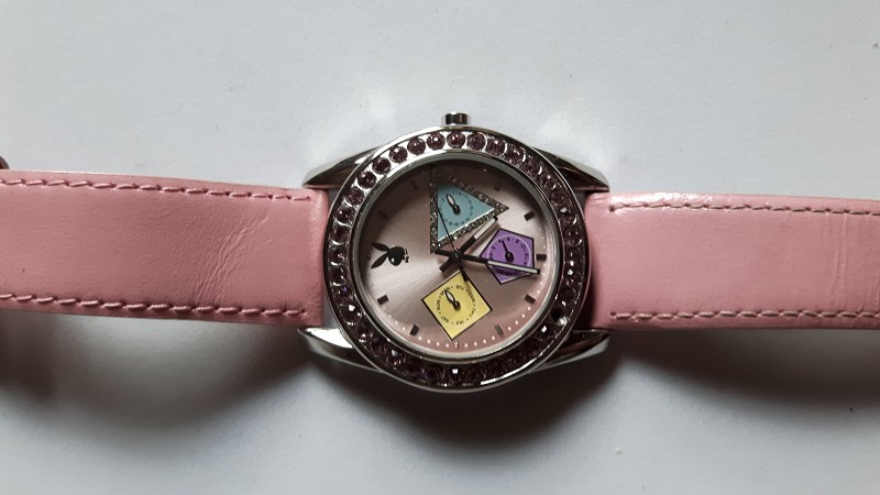 Playboy quartz watch with coloured face and original pink strap